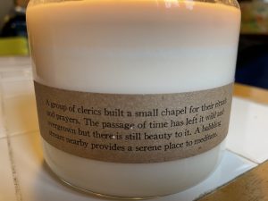 label with poetic description of Cantrip Candle's Stonemoss Chapel scent